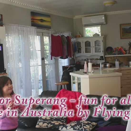 Indoor Superang boomerang being thrown inside house by two children