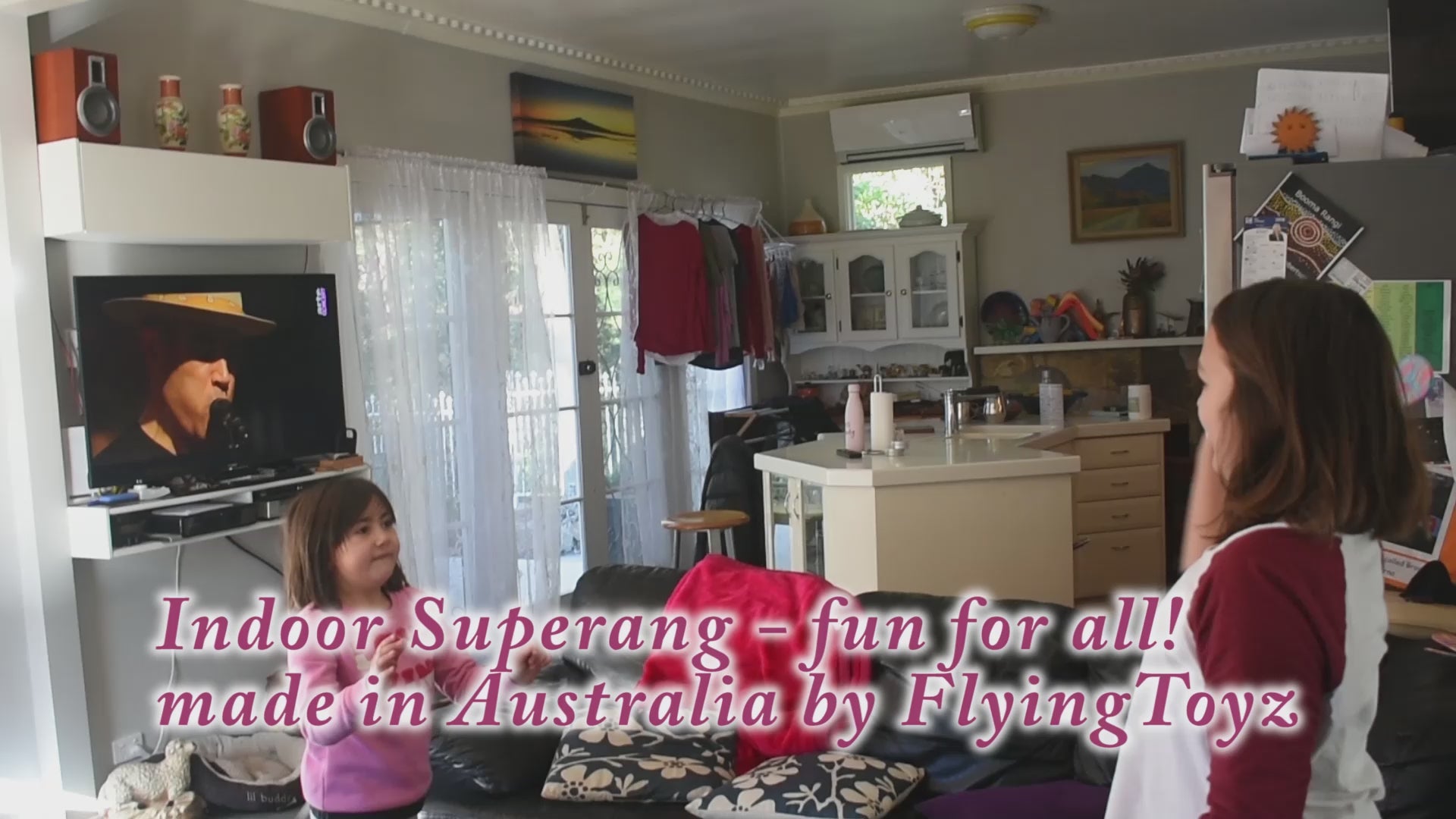 Indoor Superang boomerang being thrown inside house by two children